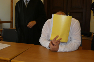 Zu lebenslanger Haft verurteilt: Marcus W. (40) verbirgt sein Gesicht zum Prozessauftakt hinter einem gelben Hefter. Foto: Lucas Böhme