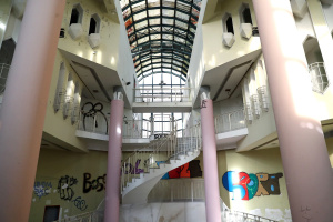 Innenhalle einer Ruine mit Fenster und Treppen.